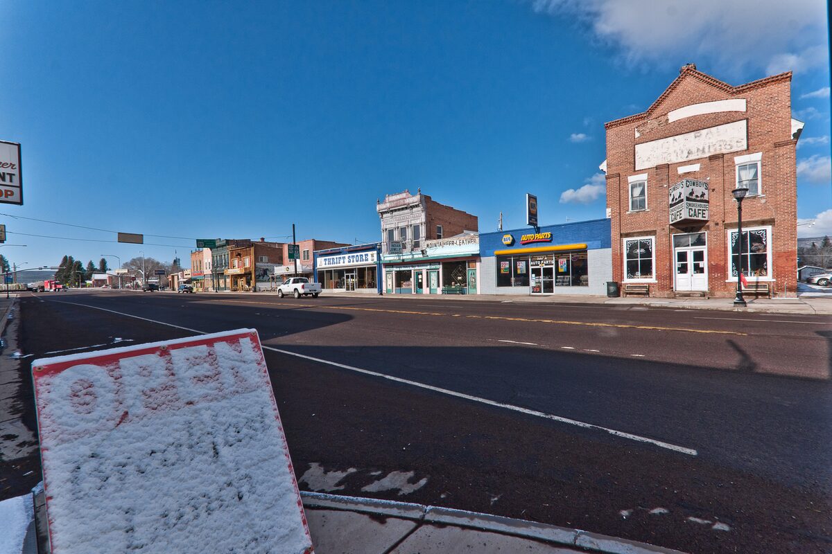 Main street of Panguitch with brick storefronts under blue sky
