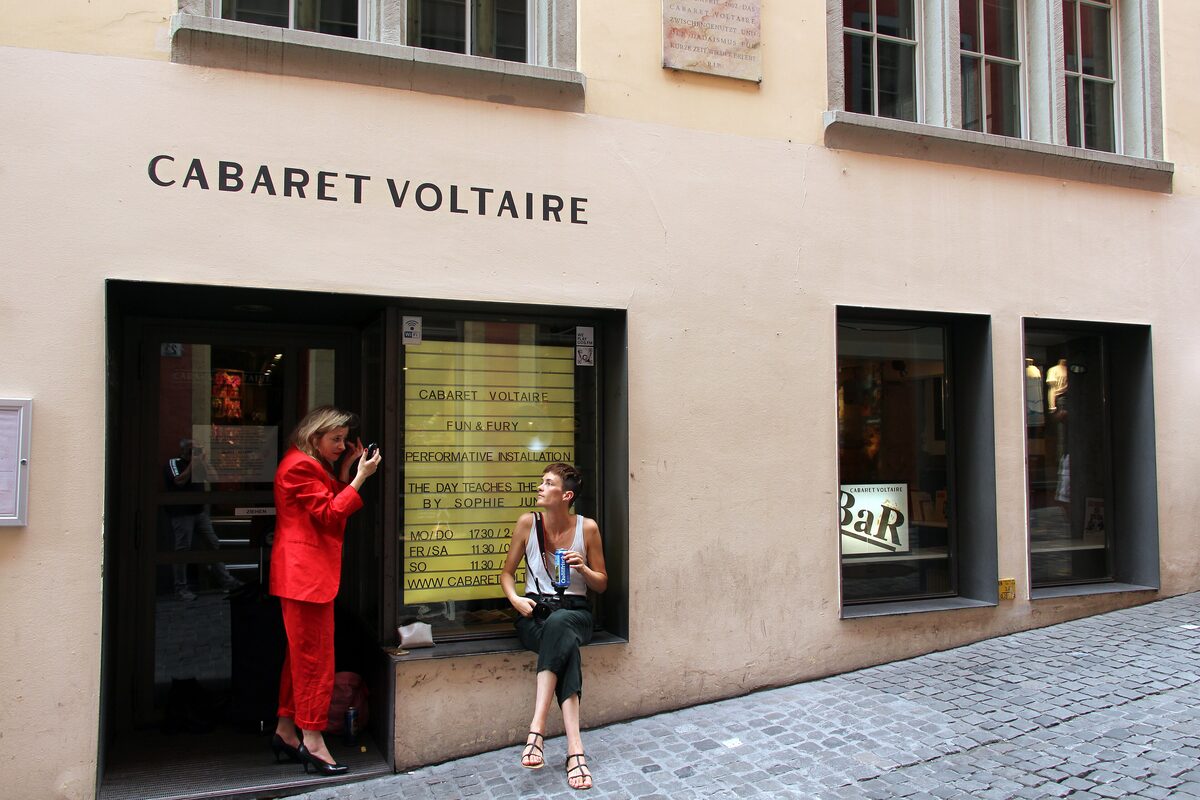 The facade and doorway of Cabaret Voltaire on a cobbled side street, with its name painted above the window