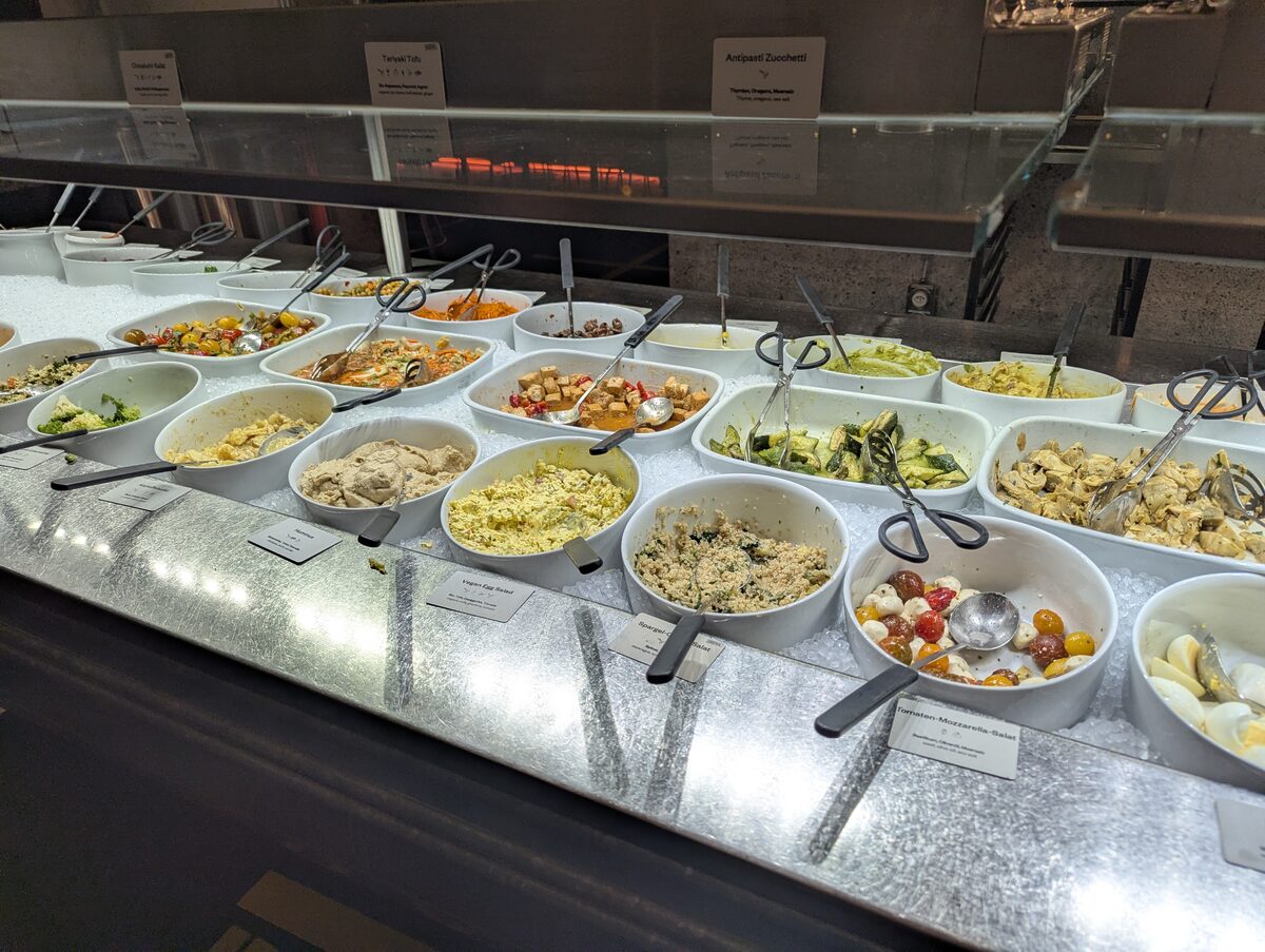 The vegetarian buffet counter at Hiltl, with rows of salad and dish bowls under glass